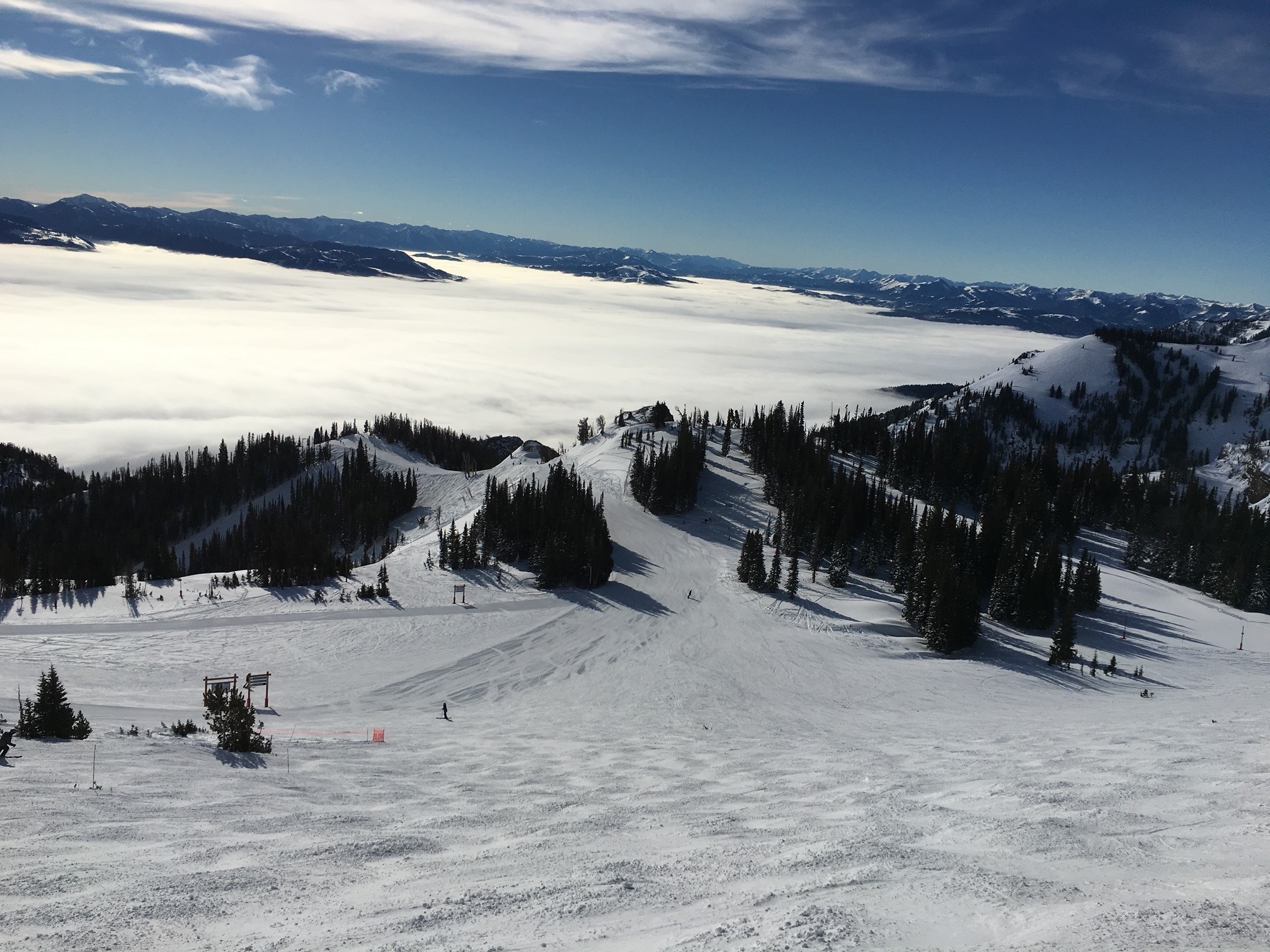 Blue bird day at Rendezvous Bowl with fog in the valley